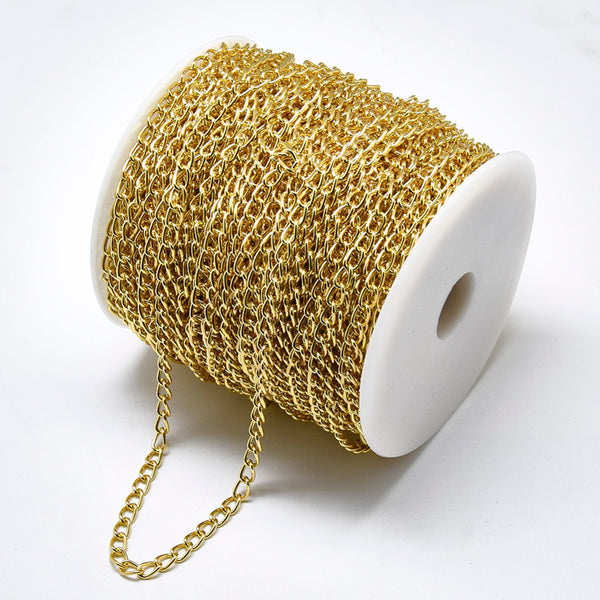 Chain Aluminum, golden, smooth with spool,, 7x4x1 mm (5mts)